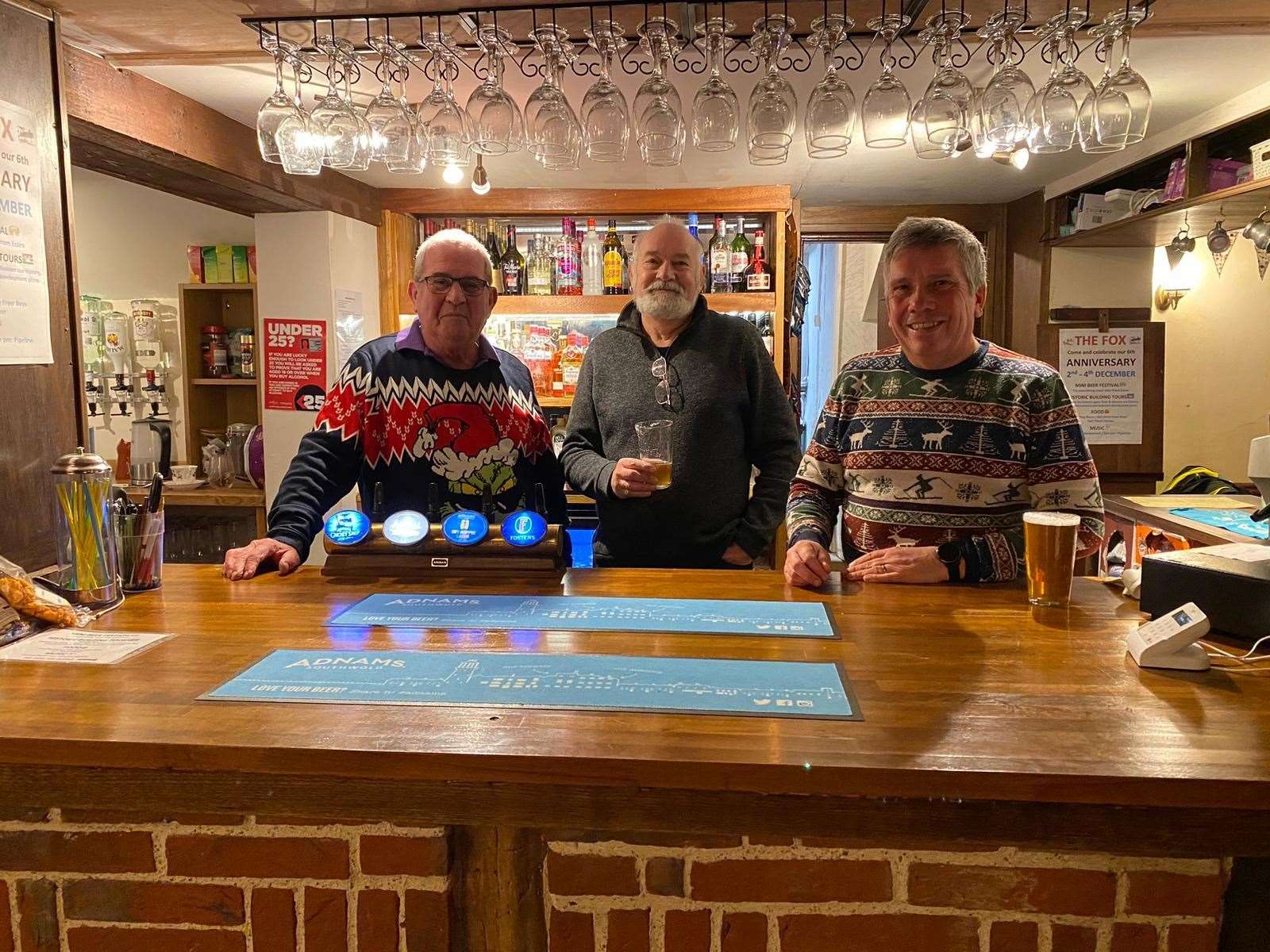 Ian Skipper (centre) with two of the pub's volunteer barmen.