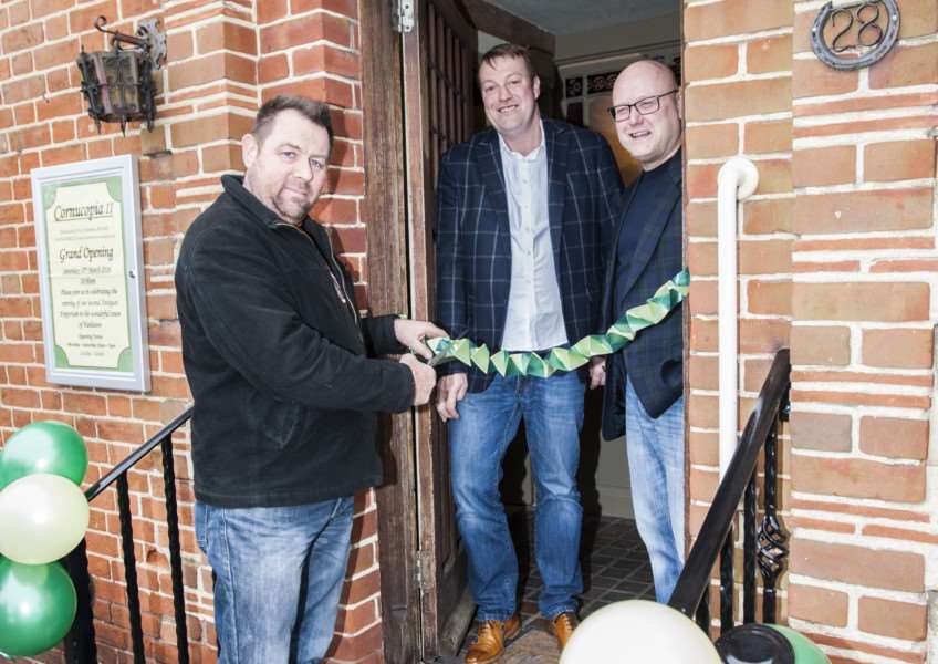 New antiques and vintage centre in Harleston. l-r Ivan Philpott cuts the ribbon, Glen Philpott, and David Charles ANL-160313-122120005