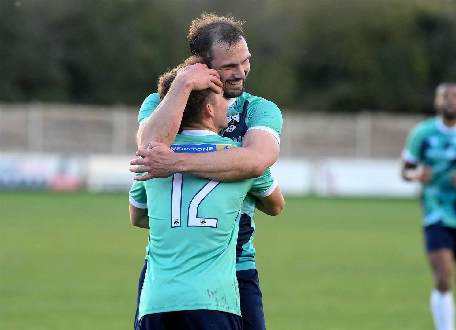 Asa McGeachy (12) is congratulated by fellow scorer Ryan Crisp after netting for Harleston Town in the second half of their FA Vase victory at Halstead Town Picture: Mecha Morton