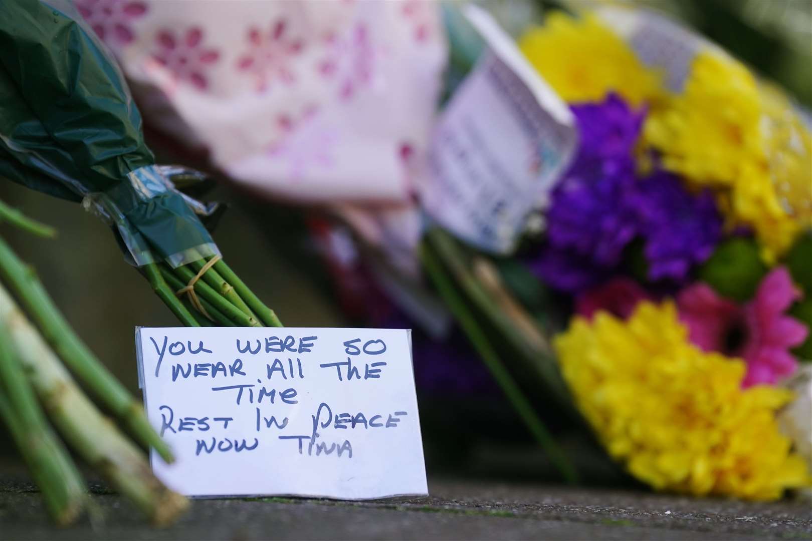 Flowers and messages left near to a property in Youghal, Co. Cork, where Tina Satchwell’s remains were discovered (Brian Lawless/PA)