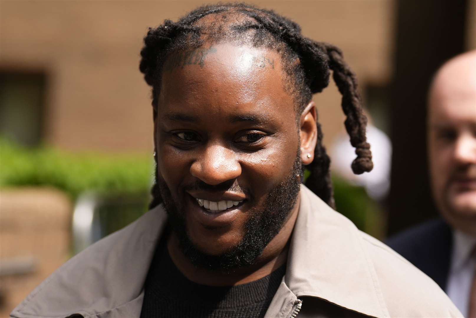US national Omololu Akinlolu, 38, leaves Southwark Crown Court (Jordan Pettitt/PA)