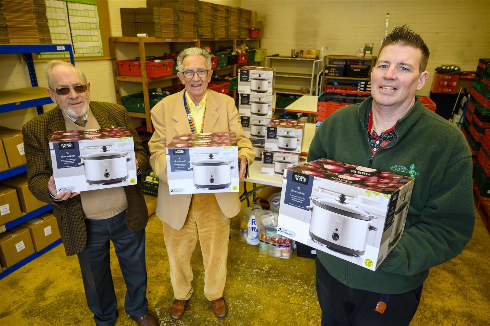 Rotary service committee member Ivor Dennison, Rotary President Graham Wuidart and Waveney Foodbank project manager Matthew Scade are pictured with the new slow cookers. Picture: Mark Bullimore Photography 2022.
