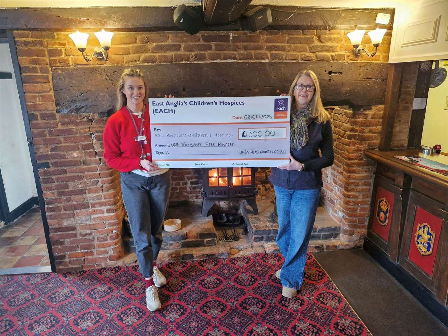 Louise Griffiths, right, presents the pub’s cheque to Ellie Miller, from Each. Picture: Contributed