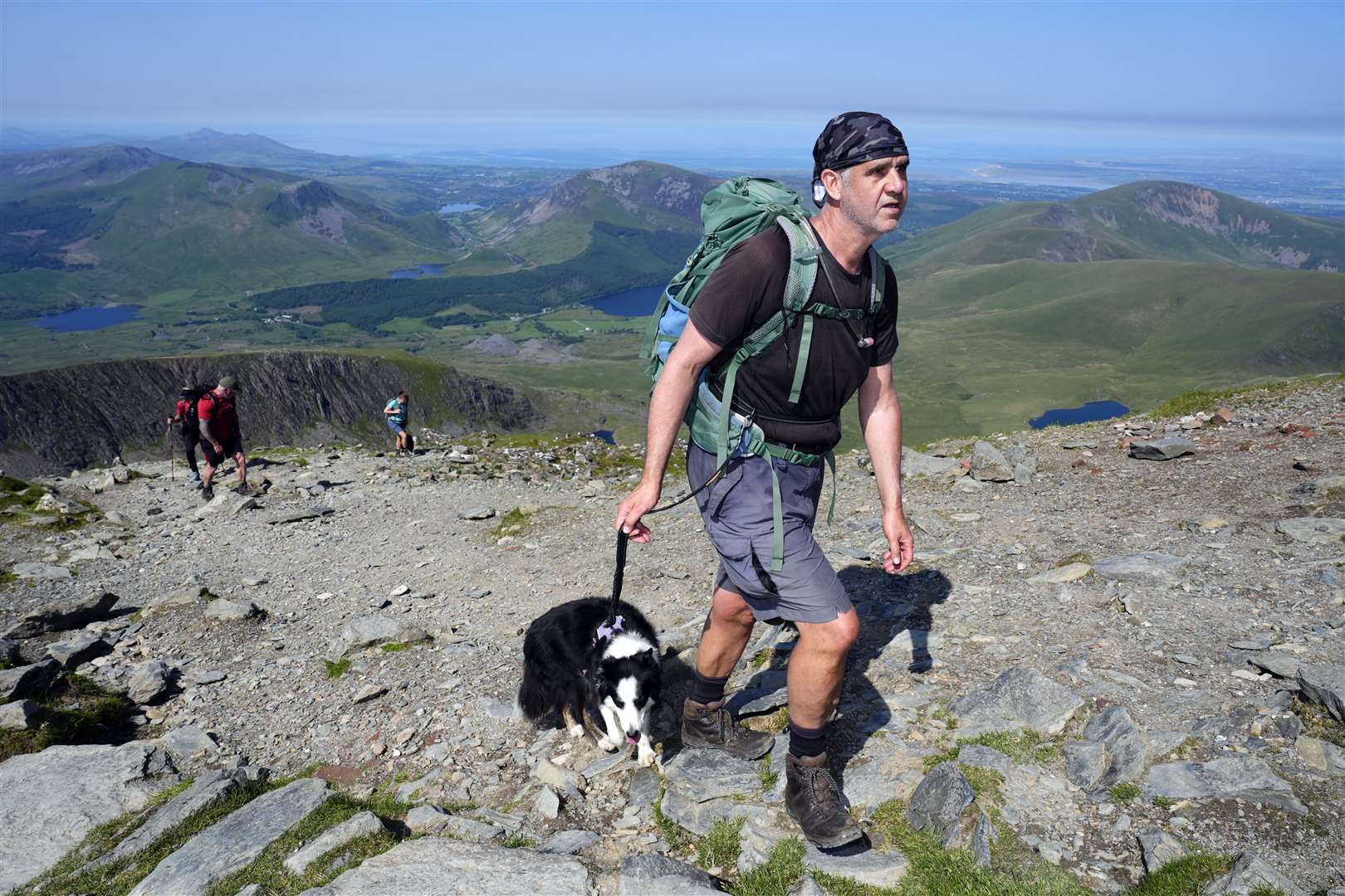 A dog joining its owner for an early morning walk in Snowdonia (Nick Potts/PA)