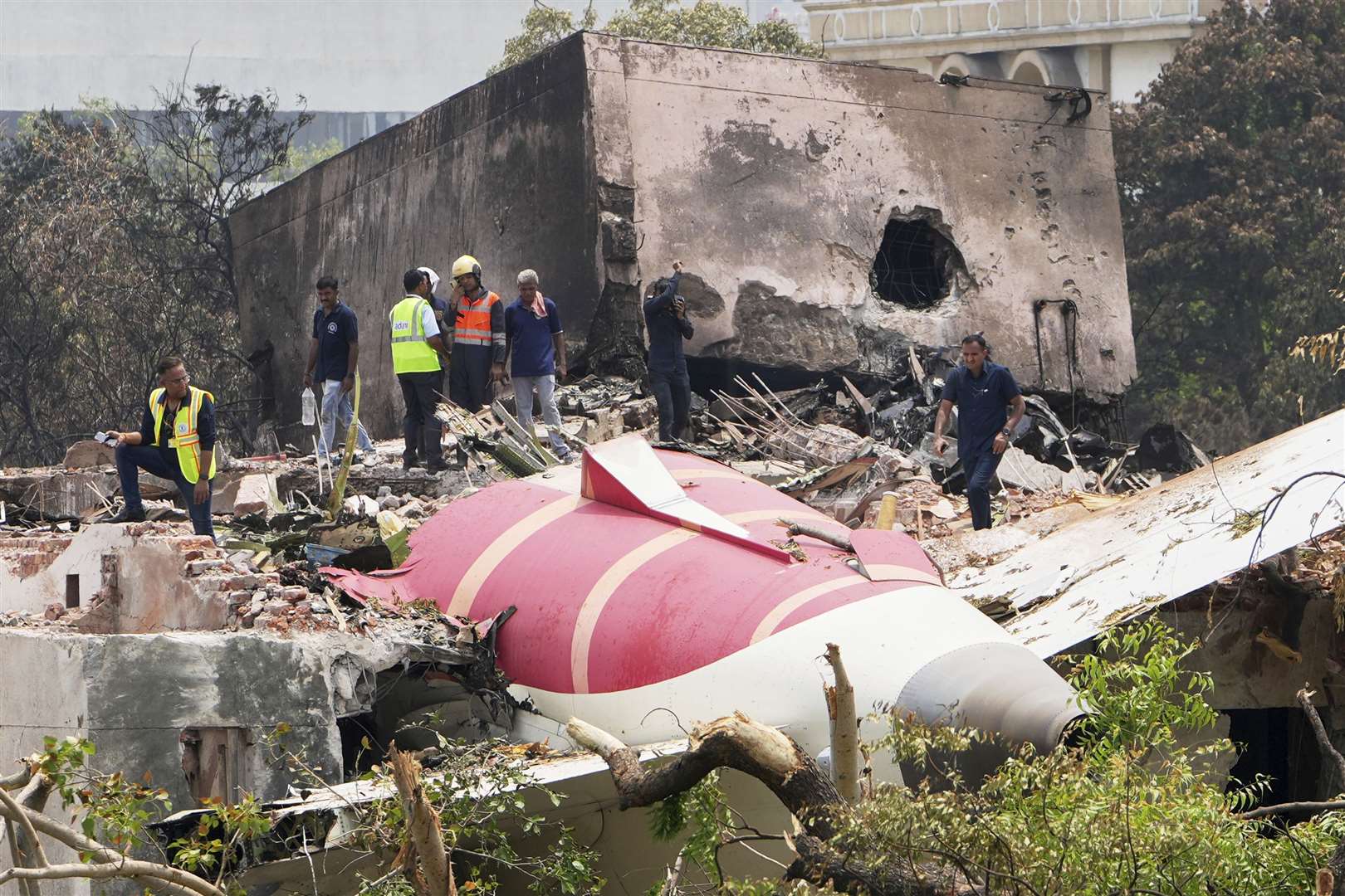 Officials inspect the site of the Air India plane crash in Ahmedabad, India (Ajit Solanki/AP)