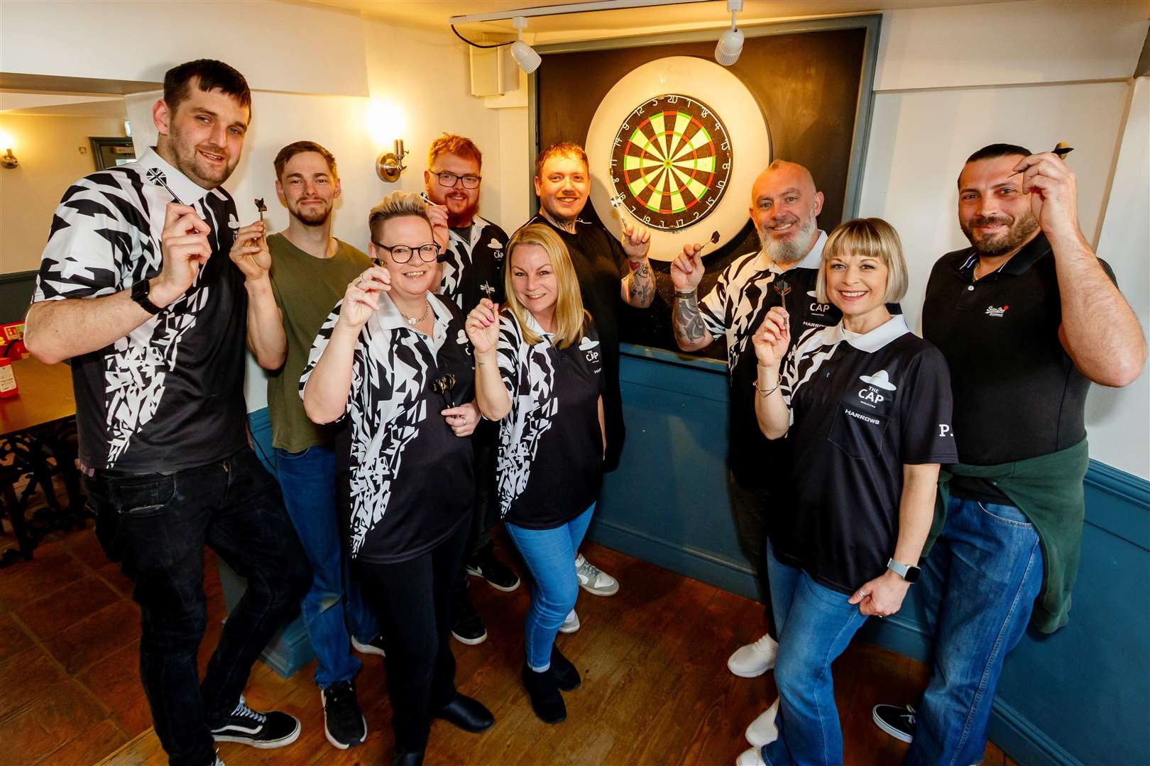 On target: Players took it in turns to keep the darts flying in during the fundraiser. Picture: Mark Bullimore