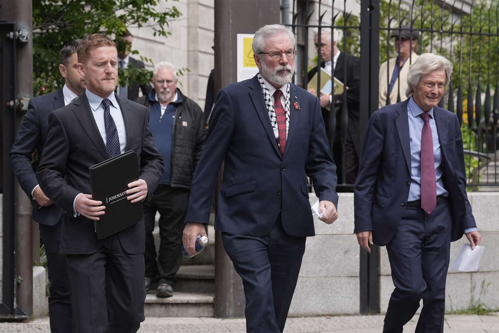 Former Sinn Fein president Gerry Adams (centre) outside the High Court in Dublin on Friday (Brian Lawless/PA)