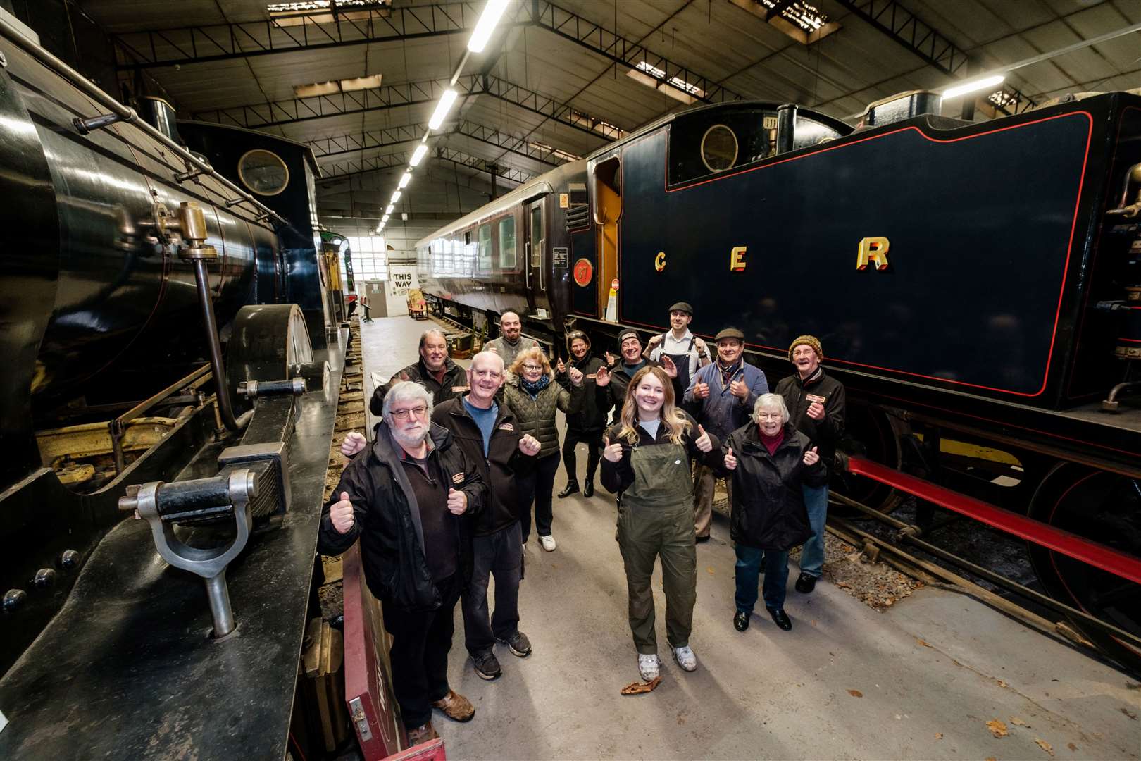 Curator Abi Mintey (centre) alongside staff and volunteers inside the main locomotive shed. Picture: Nick Strugnell