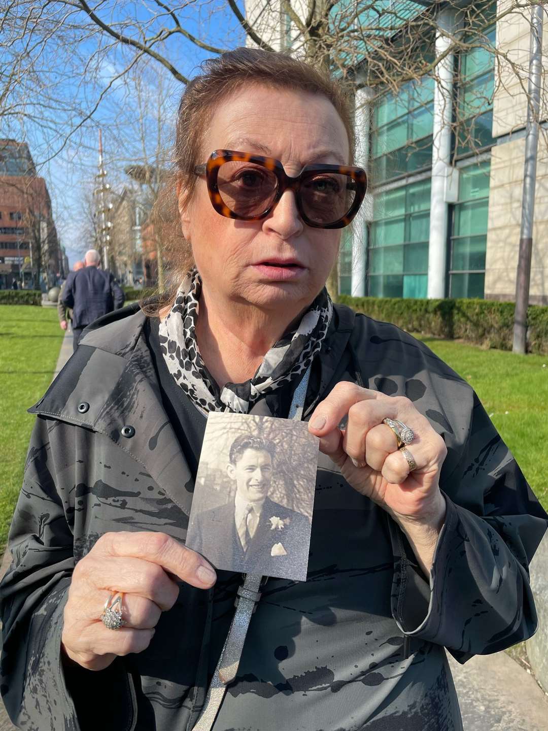 Patricia McVeigh holds a picture of her father Patrick outside Laganside court in Belfast (Sarah Collier/PA)