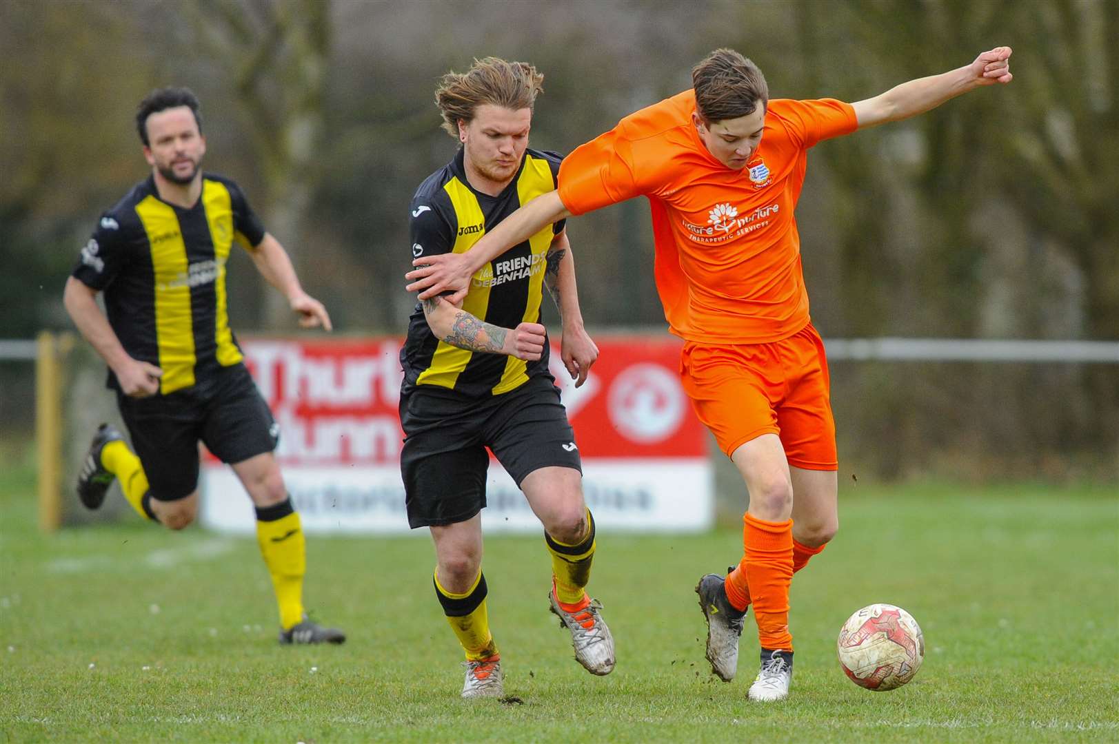 Football action from Debenham LC vs Diss Town FC ..Reece White (Deb) and Bradley Austin (Diss) ..Picture: Mark Bullimore Photography. (7821799)
