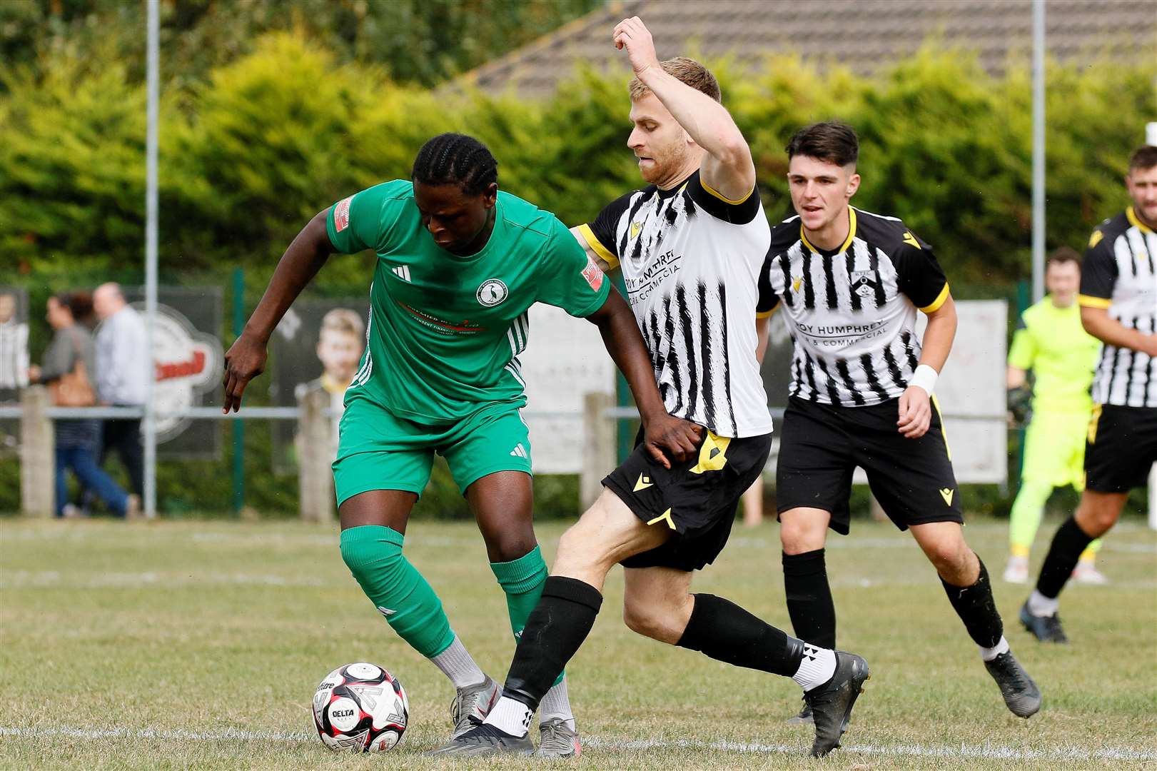 Connor Delaney looks to win possession back for Harleston. Picture: Mark Bullimore