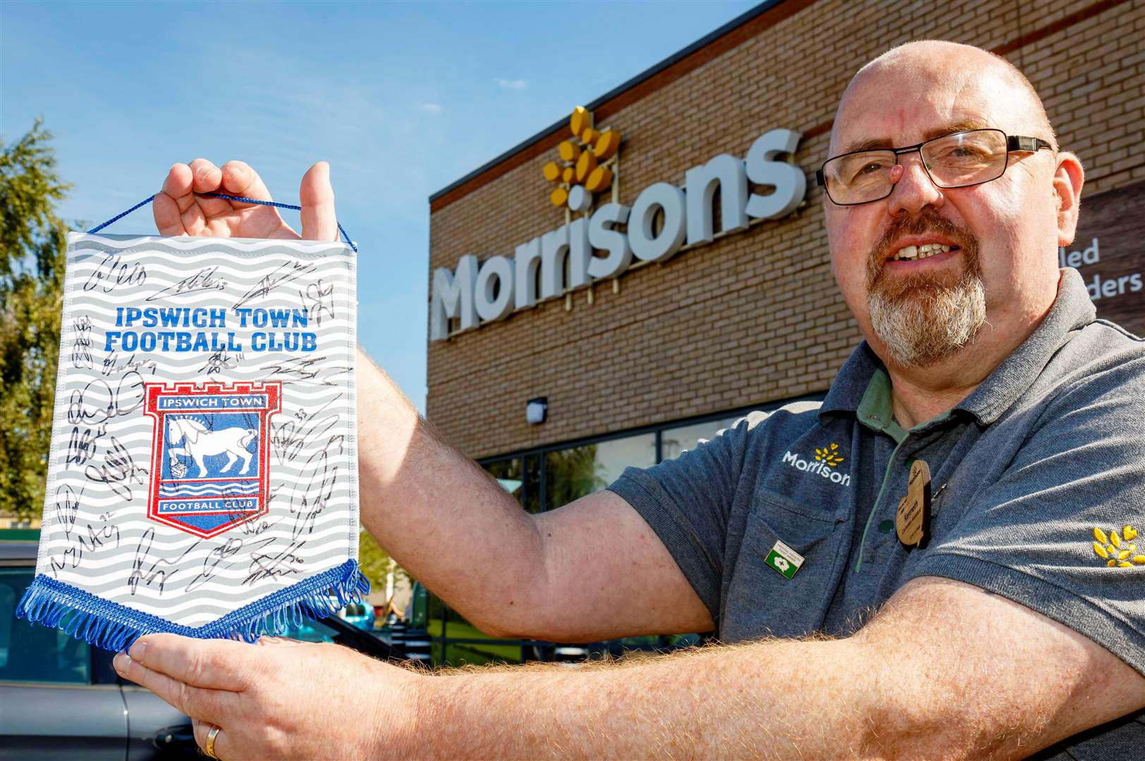 Diss, Norfolk, 23/08/2023The Morrisons’ store community champion Kenny Child is helping the store raise money for charity by doing a raffle for a pennant signed by the Ipswich Town squad.Picture: Mark Bullimore Photography 2023