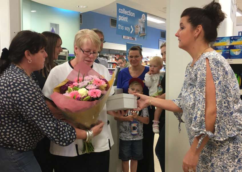 Diane Ruddock surrounded by friends and colleagues on her final day of work at Boots in Diss. Picture: Andrew Martin.