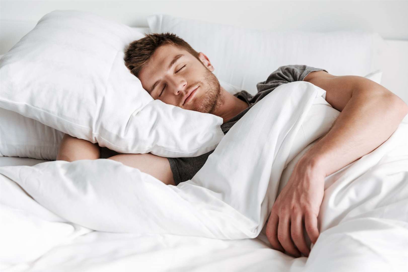 Man sleeping in bed at home.