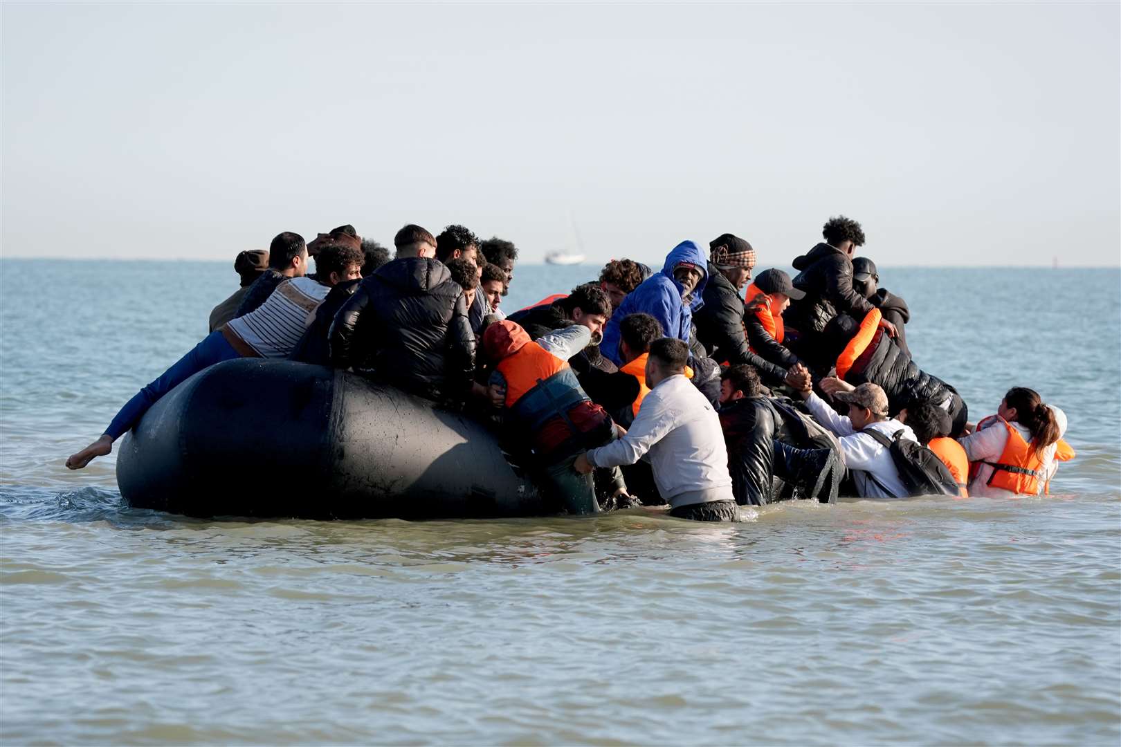 A group of people thought to be migrants on a dinghy near the beach at Gravelines, France (Gareth Fuller/PA)