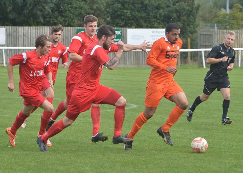 ON THE BALL: Diss Town defender Ben Lewis looks to evade the attention of his marker during his side's 2-1 defeat away at Ely City on Saturday