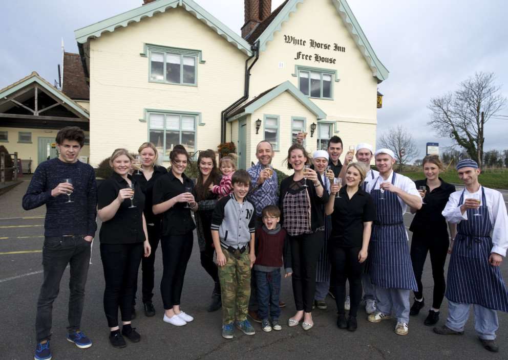 Stoke Ash, Suffolk. White Horse Inn Stoke Ash Best Bar 2014 - owners Shane Aldridge and Anne Cronin pictured with staff and their family ANL-141220-212217009