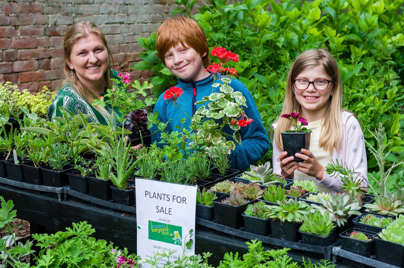 Karen Bleay of Beyond the Wall pictured with her children Harry and Jessica, who've been selling plants to raise money for the charity during lockdown.