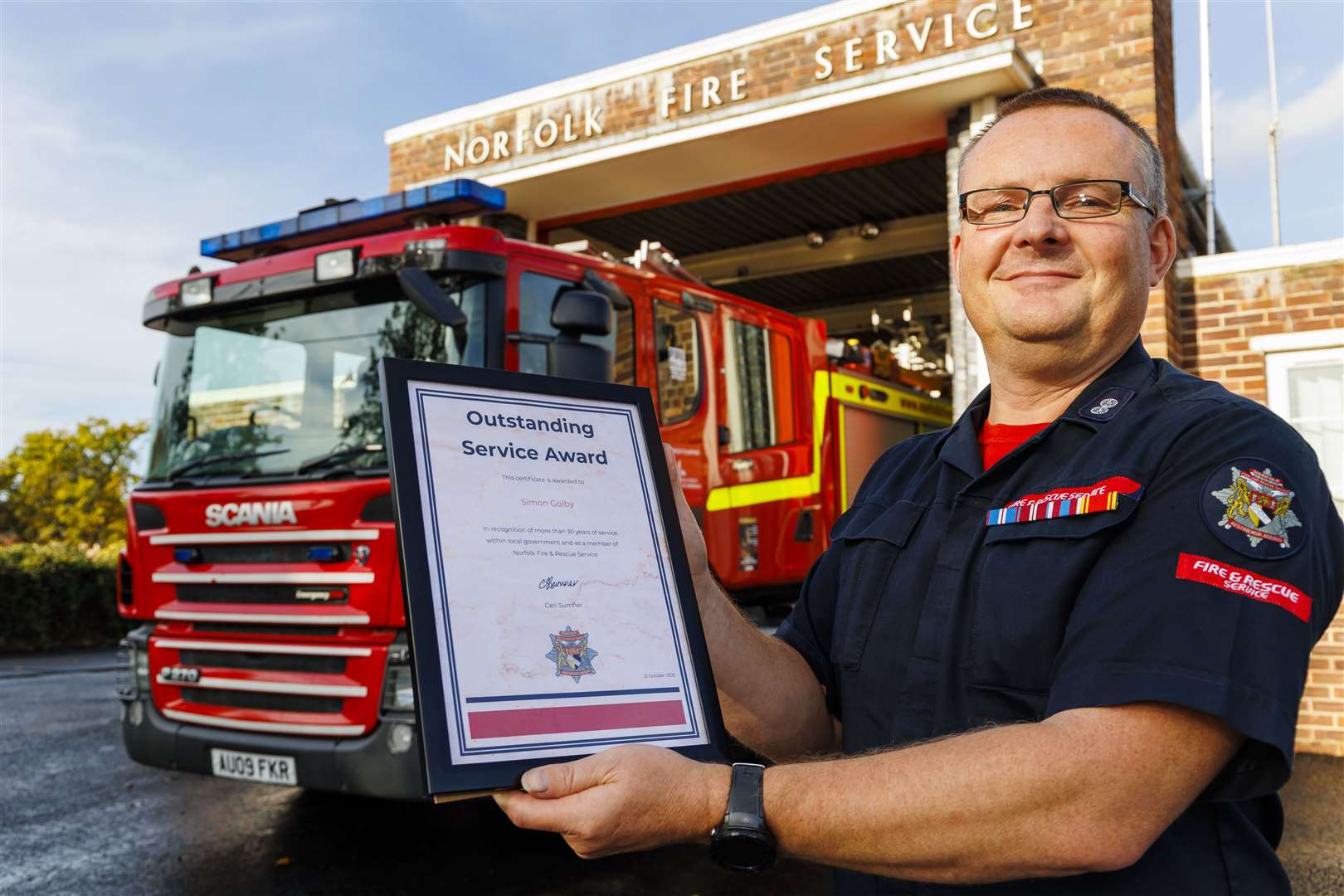 Simon Golby with his outstanding service certificate at Harleston Fire Station.Picture by Mark Bullimore