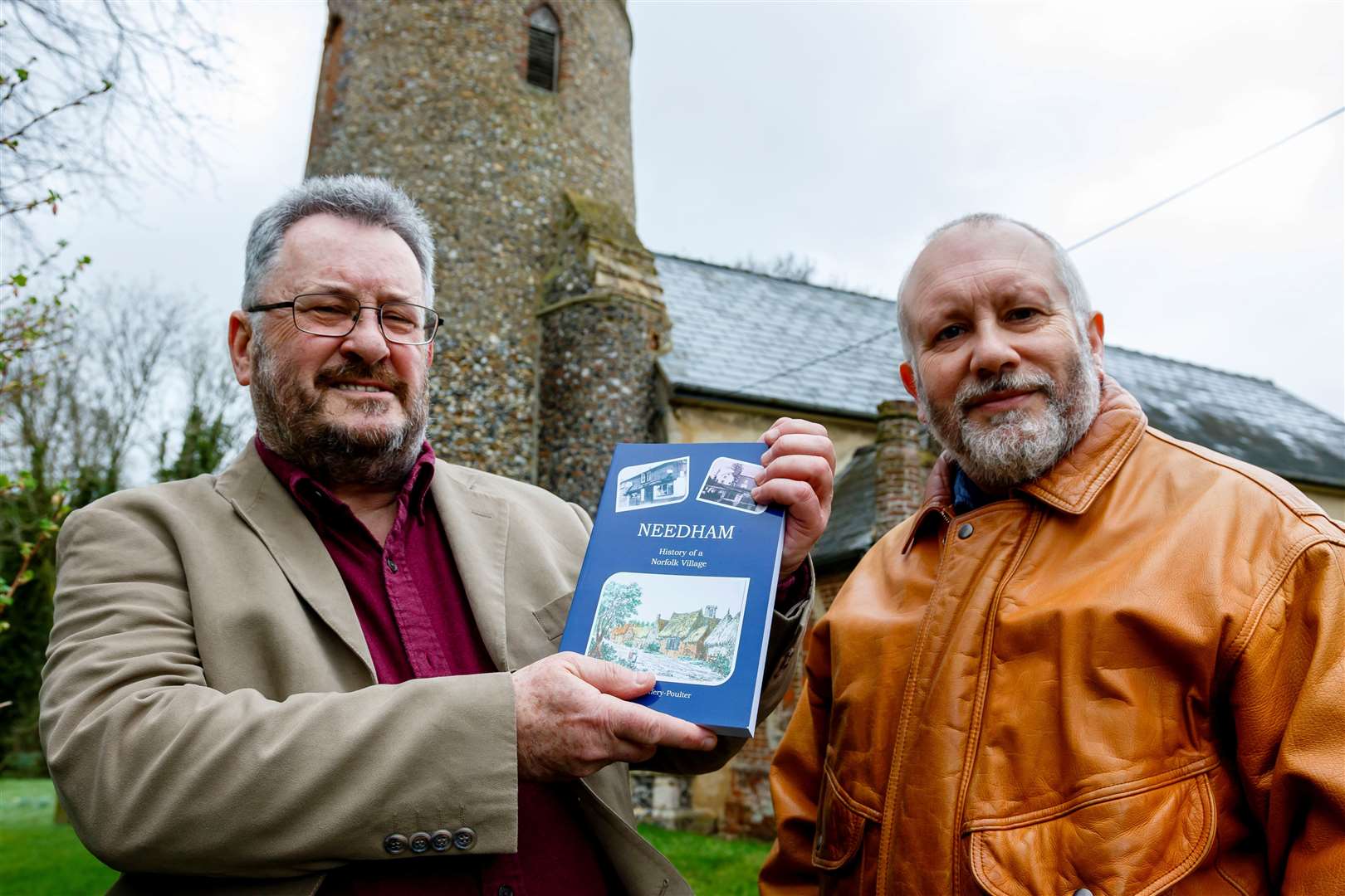 Stephen Jeffery-Poulter (left) with his book, Needham: History of a Norfolk Village and Revd Nigel Tuffnell. Picture: Mark Bullimore