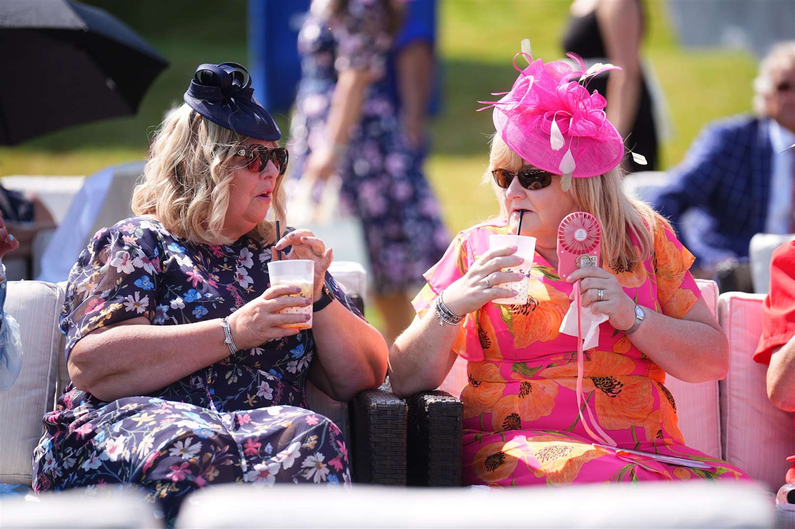These Ladies’ Day revellers sipped from drinks filled with ice (James Manning/PA)