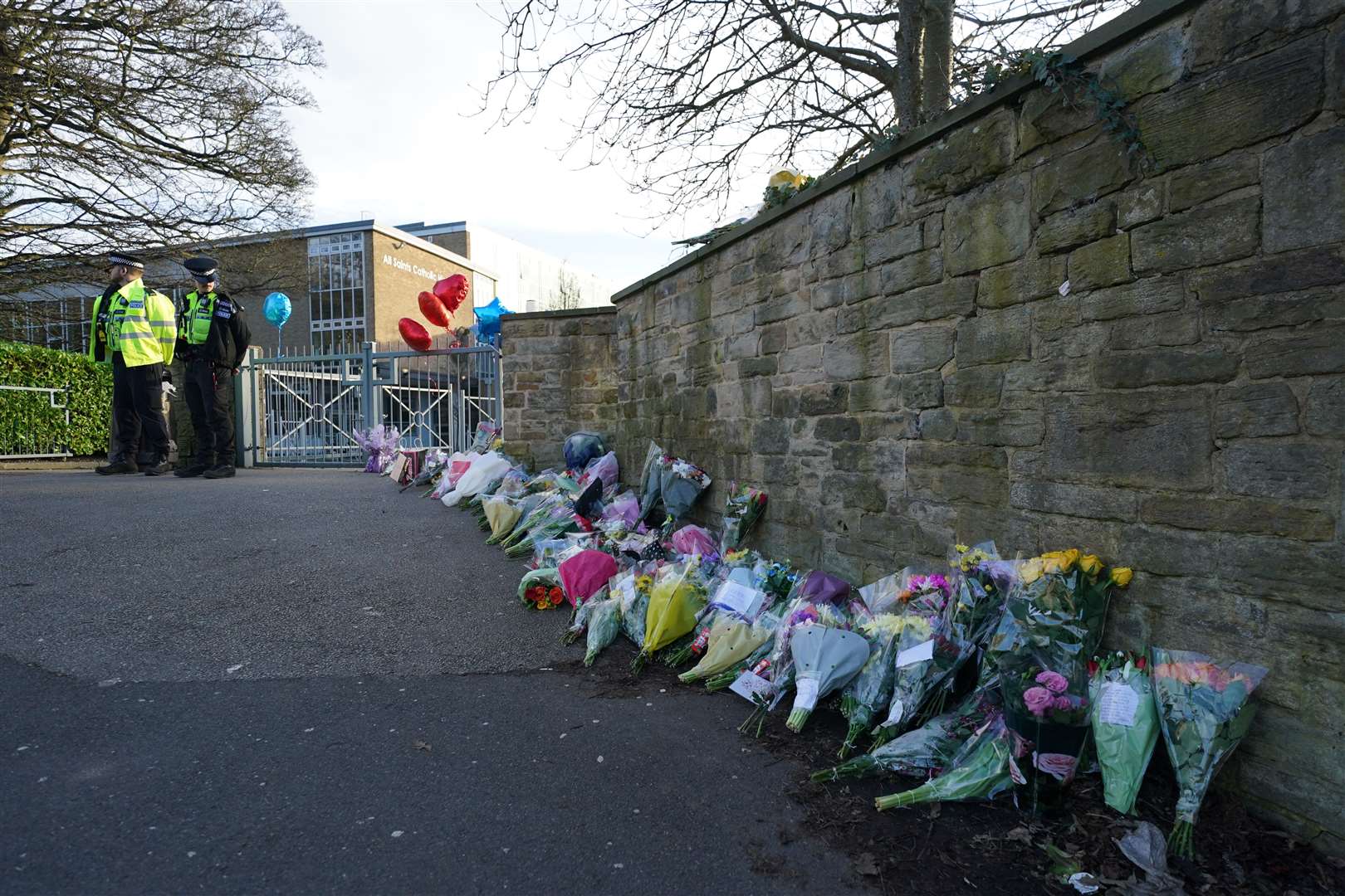 Floral tributes were left outside All Saints Catholic High School in Sheffield (Jacob King/PA)