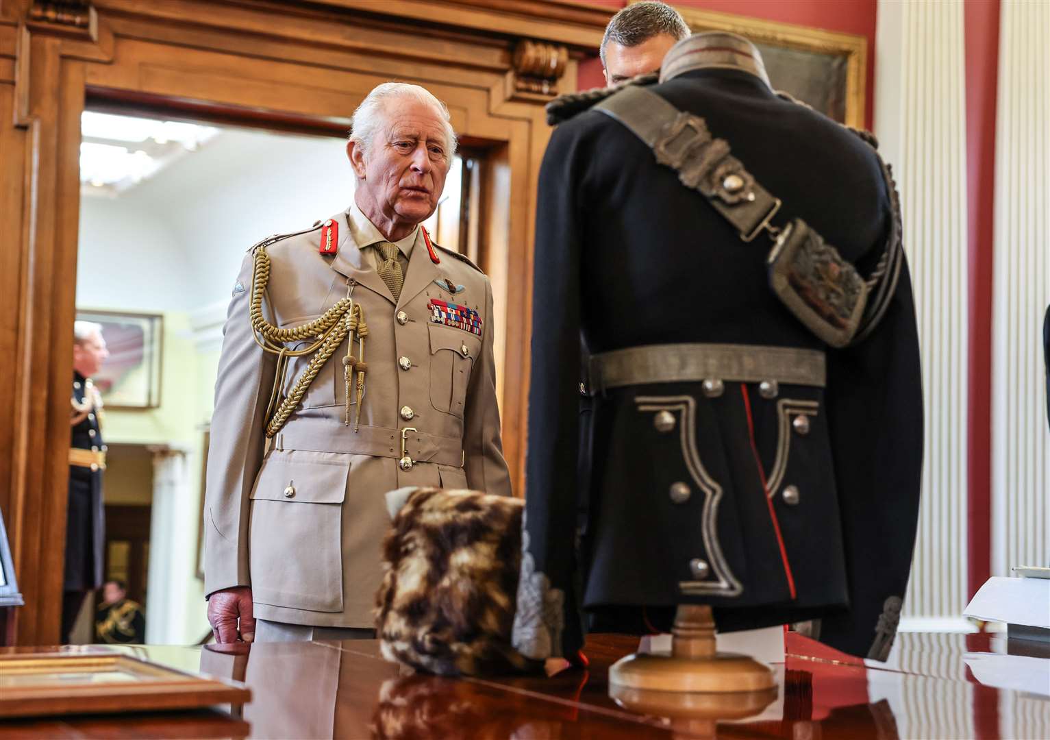 The King views the uniform of King George V in the regimental museum at the Royal Regiment of Artillery (Richard Pohle/The Times/PA)