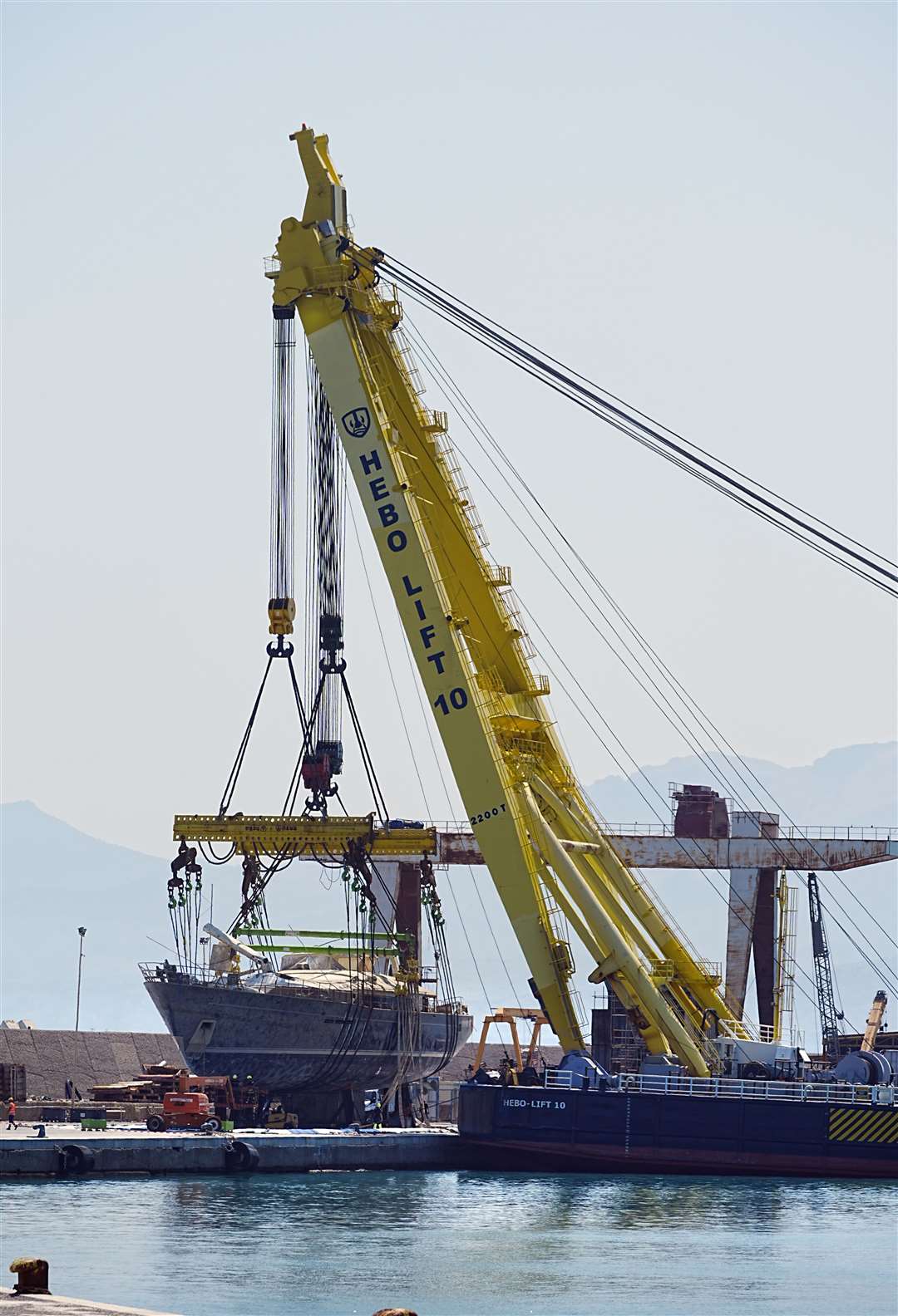 A crane lifts tech tycoon Mike Lynch’s superyacht the Bayesian (Peter Byrne/PA)