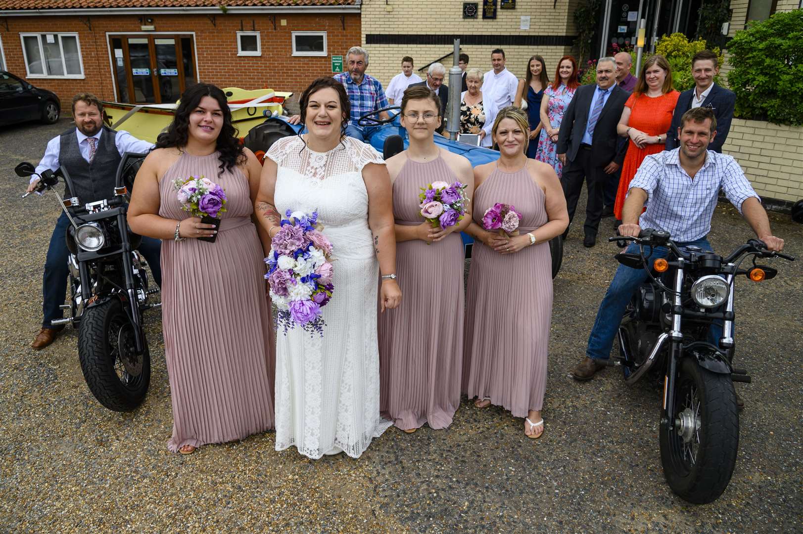 Wedding bride Maria Clarke (Groves) on part of her wedding procession down Mere Street in a tractor flanked by motorbikes. Pictured from left: Chloe Barrett, Maria Clarke (Groves), Annie grace and Becky Carter. Picture: Mark Bullimore Photography.