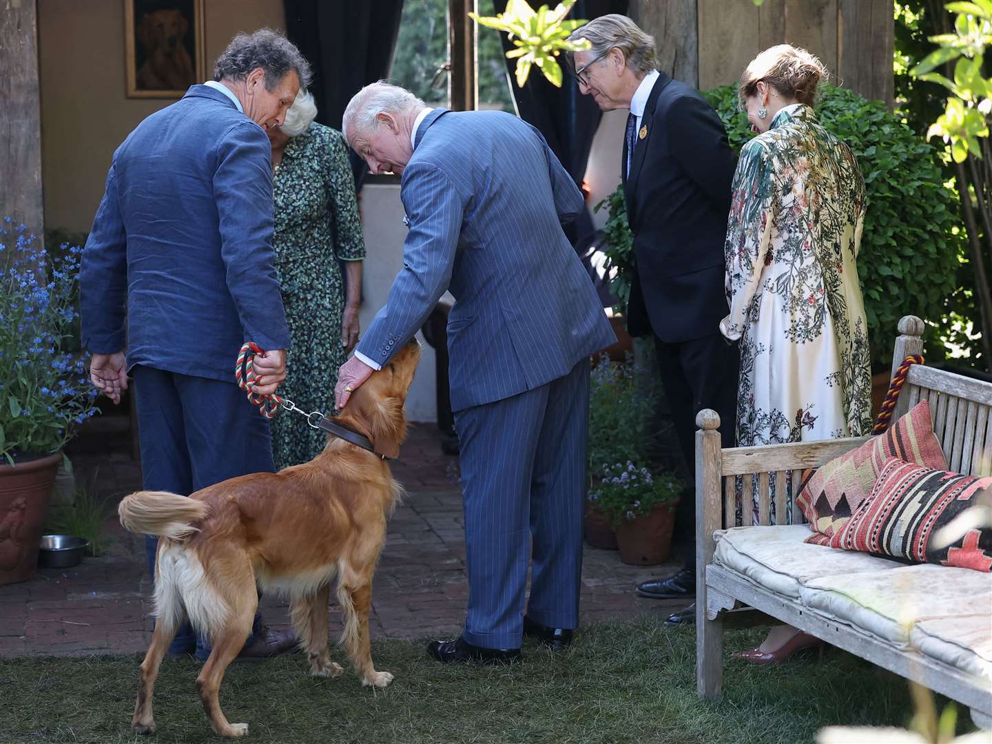 Charles pets Ned, the dog of broadcaster and gardening expert Monty Don (Toby Melville/PA)